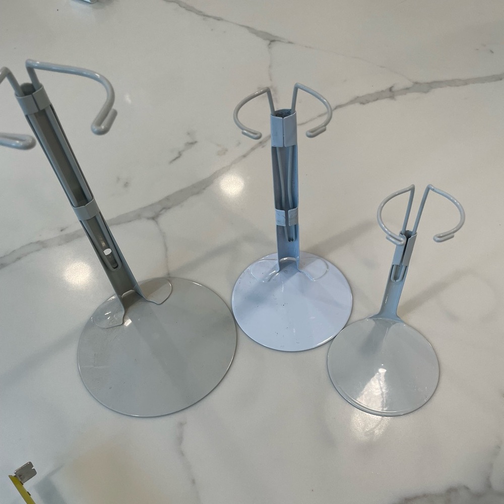Three metal doll stands